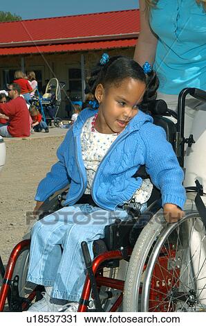 Little girl with disabilities, utilizing a wheelchair for mobility, enjoying a day outside with friends. View Large Photo Image Stock Image - Little girl with disabilities, utilizing a wheelchair for mobility, enjoying a day outside with friends.. Fotosearch