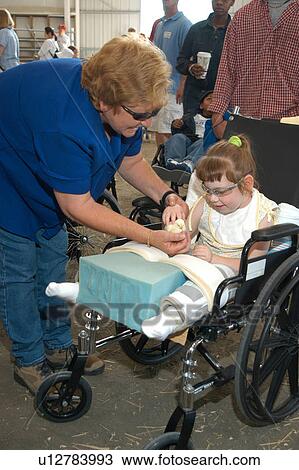 Little girl with multiple disabilities receiving some assistance from her grandmother. View Large Photo Image Stock Image - Little girl with multiple disabilities receiving some assistance from her grandmother.. Fotosearch