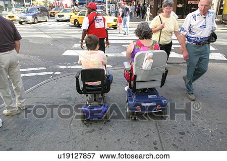 Mother and son crossing a street in New York City, using scooters/carts, while vacationing there. View Large Photo Image Stock Photo - Mother and son crossing a street in New York City, using scooters/carts, while vacationing there.. Fotosearch