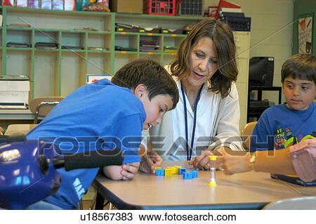 Two brothers, both with Muscular Dystrophy, working with an occupational therapist on fine motor skills. View Large Photo Image Stock Image - Two brothers, both with Muscular Dystrophy, working with an occupational therapist on fine motor skills.. Fotosearch