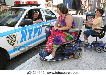 Woman and child with muscular dystrophy talking with a New York City police officer. View Large Photo Image Stock Image - Woman and child with muscular dystrophy talking with a New York City police officer.. Fotosearch