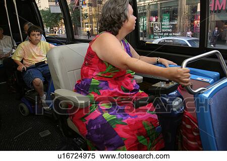 Woman utilizing a scooter/cart riding a city bus. View Large Photo Image Stock Photography - Woman utilizing a scooter/cart riding a city bus.. Fotosearch