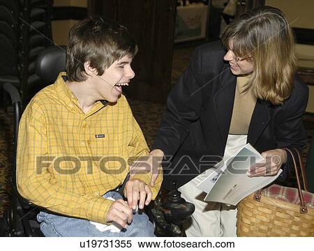 Young man with significant disabilities spending time with a friend. View Large Photo Image Stock Photography - Young man with significant disabilities spending time with a friend.. Fotosearch