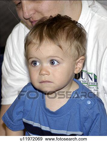 Adorable little boy with disabilities a bit unsure about what is going on. View Large Photo Image Stock Photo - Adorable little boy with disabilities a bit unsure about what is going on.. Fotosearch