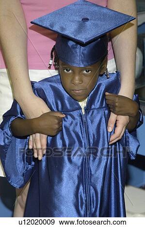 Adorable little girl with multiple disabilities awaiting the start of her preschool graduation ceremony, with the assistance of friends. View Large Photo Image Stock Photo - Adorable little girl with multiple disabilities awaiting the start of her preschool graduation ceremony, with the assistance of friends.. Fotosearch