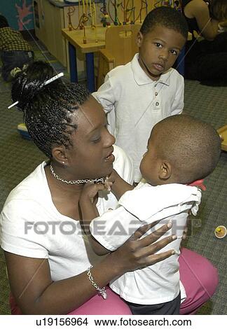 Adorable toddler looking into the eyes of his mother. View Large Photo Image Picture - Adorable toddler looking into the eyes of his mother.. Fotosearch