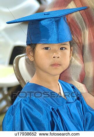 Stock Image - Beautiful child at her preschool graduation.. Fotosearch
