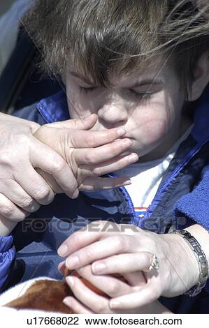 Stock Image - Boy with autism interacts through touch. Fotosearch