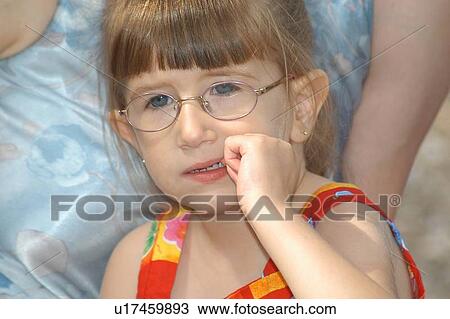Concerned face of a little girl with disabilities, including a visual impairment. View Large Photo Image Stock Image - Concerned face of a little girl with disabilities, including a visual impairment.. Fotosearch