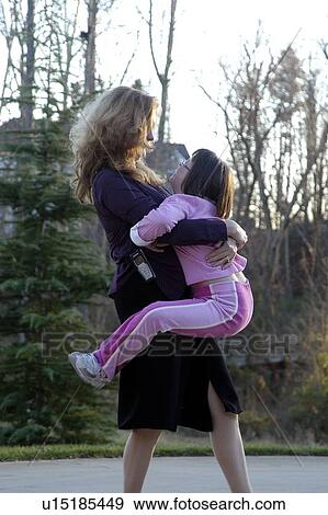 Girl with Down Syndrome having a special moment with her Mom. View Large Photo Image Stock Photo - Girl with Down Syndrome having a special moment with her Mom.. Fotosearch