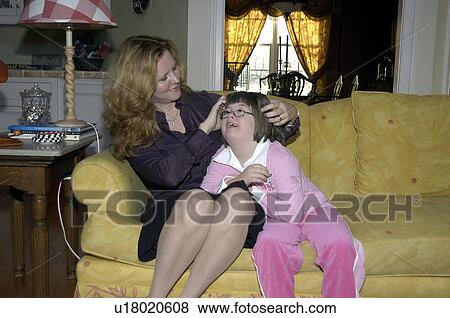 Stock Photo - Girl with Down Syndrome having a special moment with her Mom.. Fotosearch