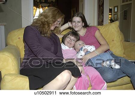 Girl with Down Syndrome spending time with her new baby sister, Mom and step-sister. View Large Photo Image Stock Image - Girl with Down Syndrome spending time with her new baby sister, Mom and step-sister.. Fotosearch