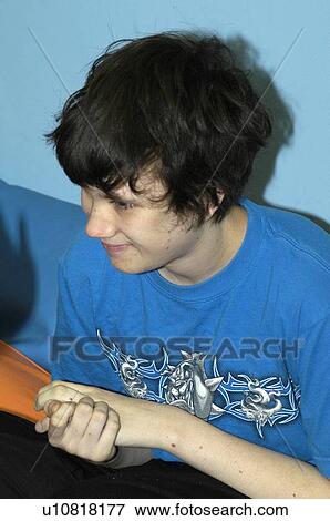Stock Photo - Image of a teenage boy with autism captured during a happy moment.. Fotosearch