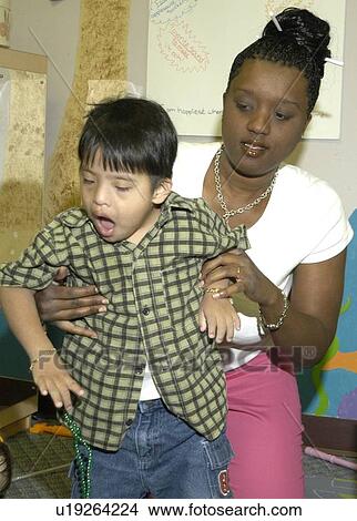 Little boy getting help with mobility. View Large Photo Image Picture - Little boy getting help with mobility.. Fotosearch