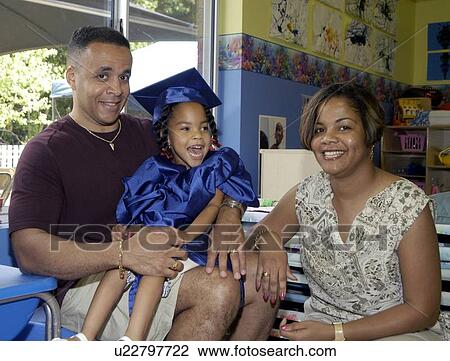 Proud and happy family on the day of their daughterÆs pre-school graduation. The little girl has multiple disabilities. View Large Photo Image Stock Image - Proud and happy family on the day of their daughterÆs pre-school graduation. The little girl has multiple disabilities.. Fotosearch