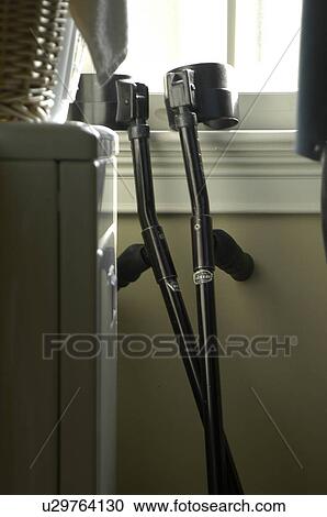 A pair of arm crutches lean again a window ledge. View Large Photo Image Stock Image - A pair of arm crutches lean again a window ledge.. Fotosearch