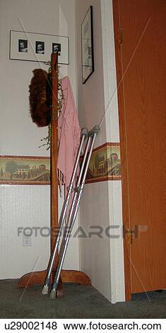 A pair of crutches lean on a wall. View Large Photo Image Stock Photo - A pair of crutches lean on a wall.. Fotosearch