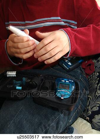 A young boy reads his daily insulin test. View Large Photo Image Stock Photo - A young boy reads his daily insulin test.. Fotosearch