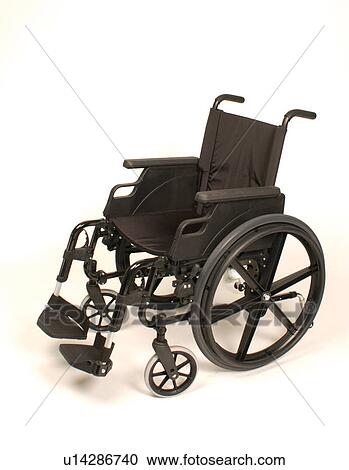 Stock Image - Basic black wheelchair. Chair is portable, and has removable foot rests.. Fotosearch