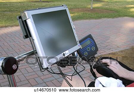 Stock Image - Communication board used by a person with a disability. This device is operated with a mouth piece.. Fotosearch
