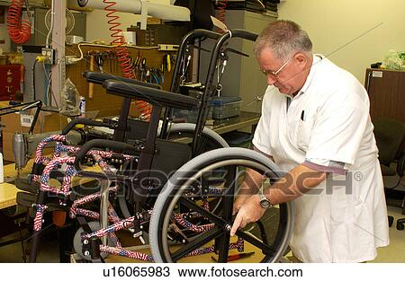 Man repairing a wheelchair. View Large Photo Image Stock Image - Man repairing a wheelchair.. Fotosearch