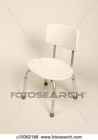 Stock Photograph - Regular size shower chair provides assistance and support to an individual with a disability with their bathing needs.. Fotosearch
