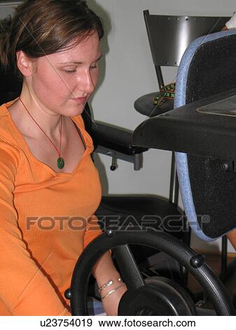 Young woman with a disability uses assistive devices. View Large Photo Image Stock Photo - Young woman with a disability uses assistive devices.. Fotosearch