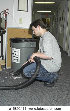 A man with a disability working is in an office vacuuming the floor. View Large Photo Image Stock Image - A man with a disability working is in an office vacuuming the floor.. Fotosearch