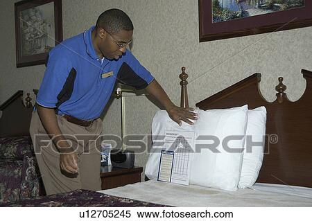 A man working changing the sheets in a hotel room. View Large Photo Image Stock Photography - A man working changing the sheets in a hotel room.. Fotosearch