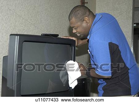 A man working dusting in a hotel room. View Large Photo Image Stock Image - A man working dusting in a hotel room.. Fotosearch