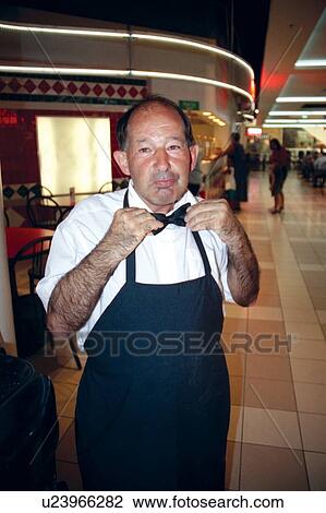 Man with a disability getting ready to start work at his job in a grocery store cafe. View Large Photo Image Stock Image - Man with a disability getting ready to start work at his job in a grocery store cafe.. Fotosearch