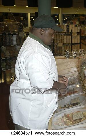 Man with disabilities working in a food store. View Large Photo Image Stock Image - Man with disabilities working in a food store.. Fotosearch