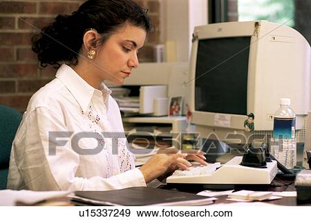 Woman who is deaf using a TTY or TDD device to communicate with clients on the telephone at her job. View Large Photo Image Stock Photo - Woman who is deaf using a TTY or TDD device to communicate with clients on the telephone at her job.. Fotosearch