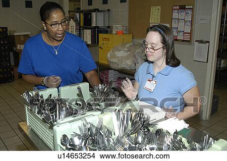 Woman with DownÆs Syndrome working in the food service industry. View Large Photo Image Picture - Woman with DownÆs Syndrome working in the food service industry.. Fotosearch