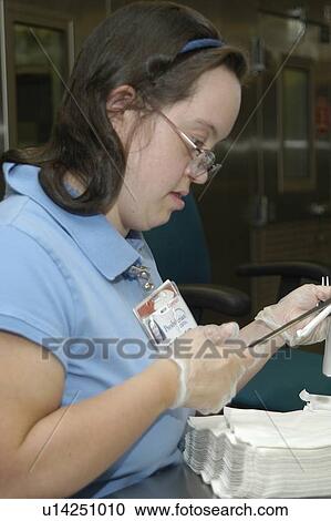 Woman with DownÆs Syndrome working in the food service industry. View Large Photo Image Stock Image - Woman with DownÆs Syndrome working in the food service industry.. Fotosearch