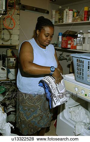 Woman working in a laundry room. View Large Photo Image Stock Photo - Woman working in a laundry room.. Fotosearch