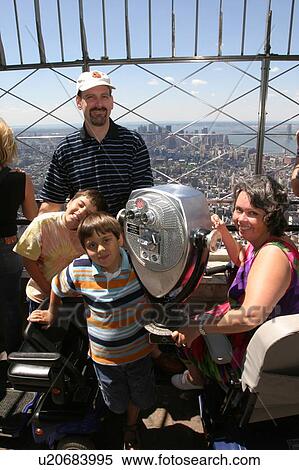 Stock Photography - A family of four having fun on vacation.. Fotosearch