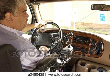 Man utilizing a wheelchair for mobility driving a van modified with hand controls. View Large Photo Image Stock Image - Man utilizing a wheelchair for mobility driving a van modified with hand controls.. Fotosearch