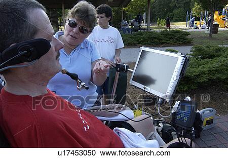 Man with a disability talking with a woman via his mouth powered communication system. View Large Photo Image Stock Image - Man with a disability talking with a woman via his mouth powered communication system.. Fotosearch