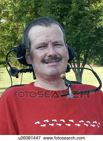 Man with significant disabilities utilizing headgear to operate communications apparatus. View Large Photo Image Stock Photo - Man with significant disabilities utilizing headgear to operate communications apparatus.. Fotosearch