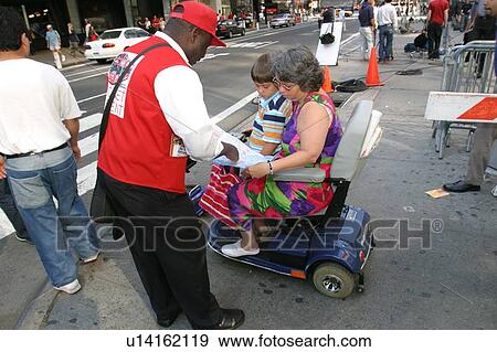 Stock Photo - Mother and sons getting directions from a guide in New York City.. Fotosearch