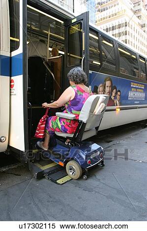 Woman using a scooter/cart for mobility getting on a city bus via a lift. View Large Photo Image Stock Photography - Woman using a scooter/cart for mobility getting on a city bus via a lift.. Fotosearch