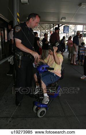A boy on a scooter talking with a New York City police officer. View Large Photo Image Stock Photography - A boy on a scooter talking with a New York City police officer.. Fotosearch