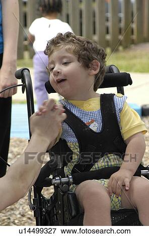 Stock Photo - A tender moment in the life of a child with severe disabilities.. Fotosearch