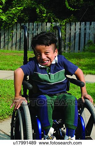 Adorable boy with a disability at his playground having a great day! View Large Photo Image Stock Photo - Adorable boy with a disability at his playground having a great day!. Fotosearch