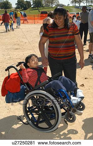 Adorable little boy with multiple disabilities having a blast with his mom at a petting zoo with his friends. View Large Photo Image Stock Image - Adorable little boy with multiple disabilities having a blast with his mom at a petting zoo with his friends.. Fotosearch