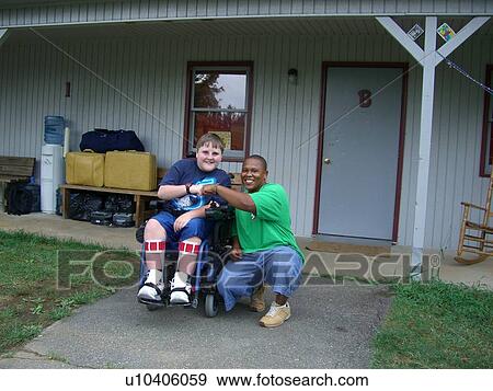 Boy, in wheelchair, with his camp counselor. View Large Photo Image Stock Photo - Boy, in wheelchair, with his camp counselor.. Fotosearch