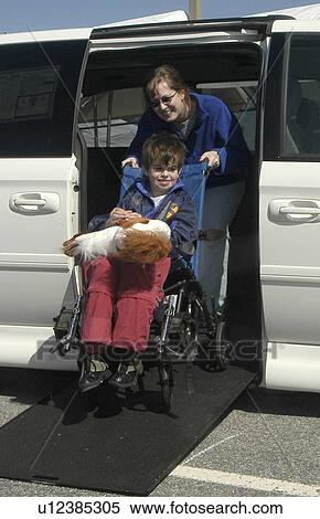 Boy with autism and Mom use ramp to exit family van View Large Photo Image Stock Photography - Boy with autism and Mom use ramp to exit family van. Fotosearch