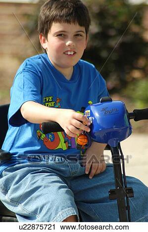 Boy with Muscular Dystrophy utilizing a scooter/cart for mobility enjoying a sunny day. View Large Photo Image Stock Image - Boy with Muscular Dystrophy utilizing a scooter/cart for mobility enjoying a sunny day.. Fotosearch