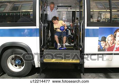 Boy with Muscular Dystrophy, utilizing a scooter/cart for mobility, exiting a city bus via a chair lift. View Large Photo Image Stock Photo - Boy with Muscular Dystrophy, utilizing a scooter/cart for mobility, exiting a city bus via a chair lift.. Fotosearch